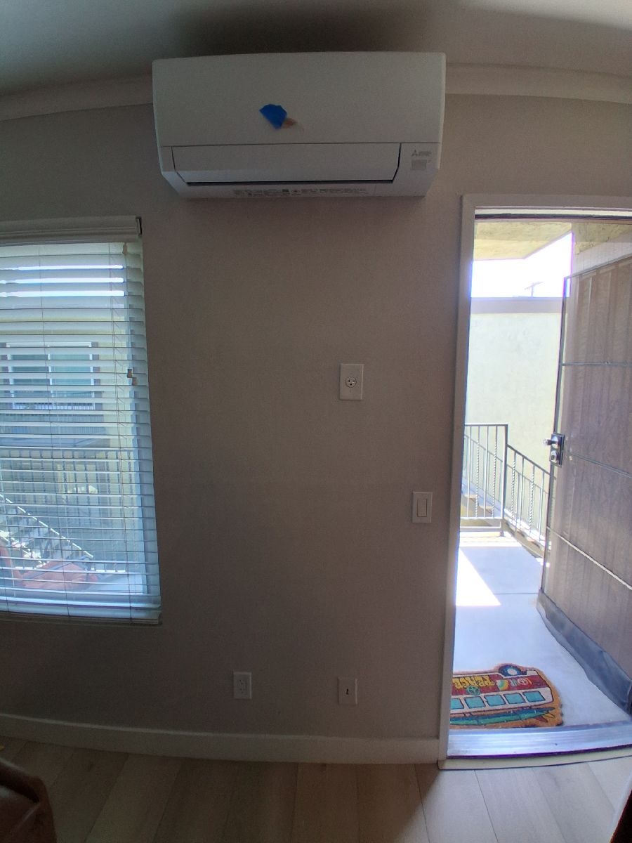 Finished interior wall below a wall-mounted mini-split